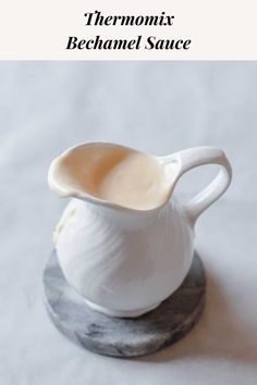 a white ceramic pitcher sitting on top of a marble base with the words, thermonix bechamel sauce