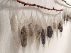 there are many different things hanging on the wall in this room and one is made out of netting