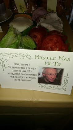 a table topped with lots of different types of food and a card on top of it