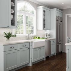 a kitchen with gray cabinets and white counter tops