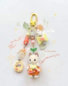 a keychain with an animal charm attached to it's front and back ends