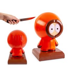 a person is holding a knife over an orange object that looks like a cartoon character