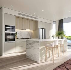 a kitchen with marble counter tops and white chairs