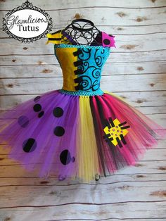 a dress made out of tulle with black and yellow polka dots on the bottom