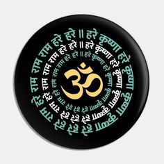 a black and green button with the word om shanti written in different languages on it