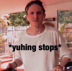 a man standing in front of a table with food on it and the words yummy stops above him