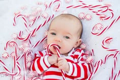 a baby laying on top of candy canes