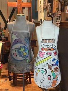 two mannequins with aprons painted on them