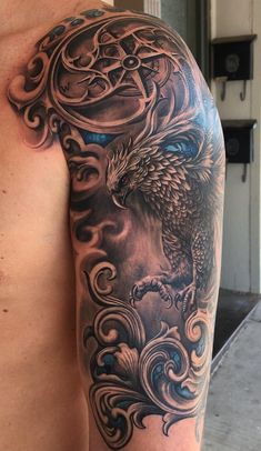 a man's arm with an eagle and clouds tattoo on the left side of his body