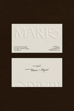 two white business cards with the word's name on them