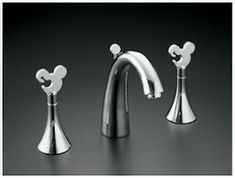 three chrome colored faucets with mickey mouse heads on the top and bottom handles