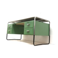 a green desk with two drawers underneath it