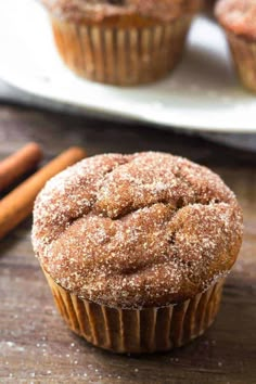 cinnamon sugar muffins on a plate with cinnamon sticks