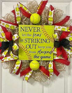 a baseball wreath on the front door with a sign that says never let the feel of striking out keep you from having the game