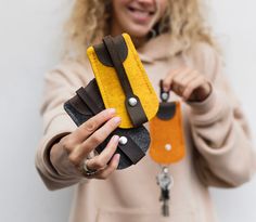 a woman holding a pair of scissors in one hand and a piece of fabric in the other