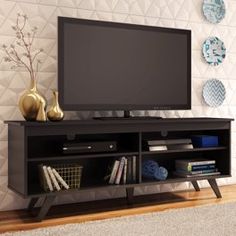 a flat screen tv sitting on top of a black entertainment center