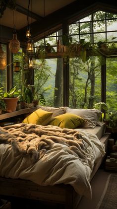 a bed sitting in a bedroom next to a window filled with lots of green plants