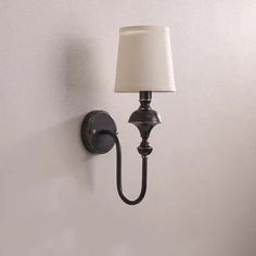 a wall light with a white shade on it