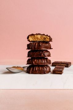 a stack of chocolate covered cookies sitting on top of a counter