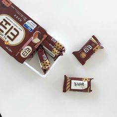 three chocolate bars sitting next to each other on top of a white table with chinese writing