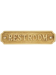 a brass metal sign that says rest room