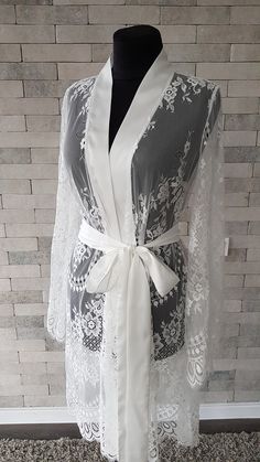 Off-white luxurious wedding robe, to add a perfect touch to your perfect and unique day. Only high quality fabrics and high finishing used for making the robe as neat as it can be. Please find the wedding robes collection here https://www.etsy.com/shop/LidiasBoutiqueDesign?ref=seller-platform-mcnav&section_id=25023222. For wedding dresses, please access https://www.etsy.com/shop/LidiasBoutiqueDesign?ref=seller-platform-mcnav§ion_id=23157290. For wedding tops and boleros, please access https: Elegant Lace Trim Wedding Dress, Feminine Lace Gown With Lace Bodice, Feminine Lace Bodice Gown, Feminine Wedding Night Dress With Contrast Lace, Elegant Lace Dress For Wedding, Feminine Wedding Dress With Contrast Lace, Feminine Contrast Lace Dress For Wedding Night, Elegant White Gown For Mother Of The Bride, Elegant White Mother Of The Bride Gown