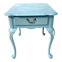 a small blue table with gold handles on it