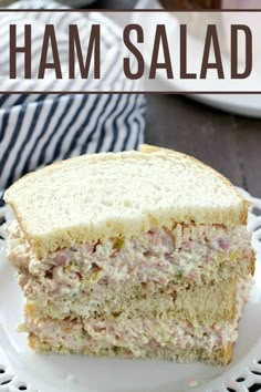 ham salad sandwich cut in half on a white plate