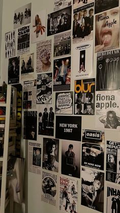 the wall is covered with many different posters