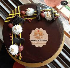 a chocolate cake with white and yellow decorations