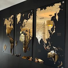 the world map is on display in front of black walls with gold foiled accents