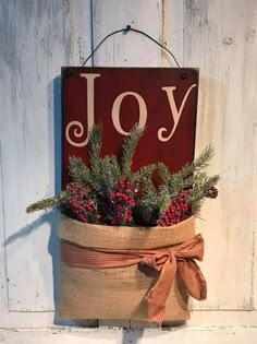 a christmas decoration hanging on the side of a building with a joy sign above it