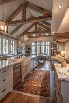 a large kitchen with wooden beams and an area rug on the floor in front of it