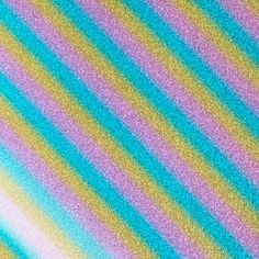 a multicolored striped background with some blurry colors on it's surface