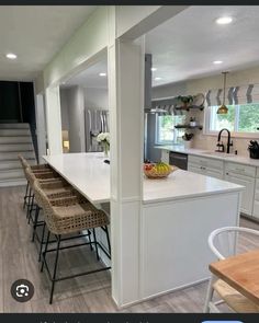 the kitchen is clean and ready to be used for cooking or eating, while the stairs lead up to the second floor