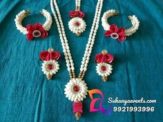 the necklaces and earrings are decorated with flowers