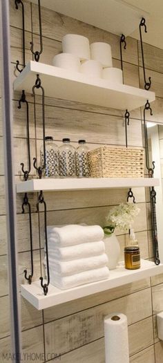 a bathroom with shelving above the sink and toilet paper on the shelf next to it