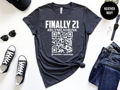 Turn your milestone birthday into a party that never ends with our "Finally 21" shirt! This fun, stylish shirt is perfect for anyone ready to celebrate their big day and get the drinks flowing. Featuring the phrase "Finally 21," this shirt announces you've officially reached the legal drinking age in style--plus, it includes a QR code that makes it easy for friends (and even strangers) to buy you a drink! Finally 21 Shirt, Buy me a Drink, Buy me a Shot, 21st Birthday Gift, Custom Birthday Shirt, 21st Birthday Gifts For Guys, Funny Bachelorette Shirts, 21st Birthday Shirts, Birthday Squad Shirts, 21st Birthday Outfits, Turning 21, 21 Shirt, Custom Birthday Shirts, 21 Birthday