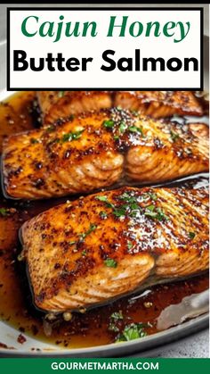 two grilled salmon fillets on a white plate with brown gravy