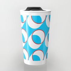 a blue and white coffee cup with circles on it