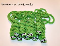 there is a green crocheted bookmark with eyes on it