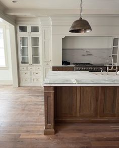 a large kitchen with an island in the middle