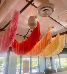 colorful streamers hanging from the ceiling in a restaurant