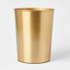 a gold colored cup on a white background