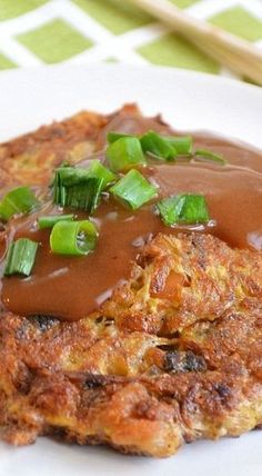 a close up of a plate of food with gravy and vegetables on it