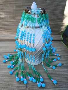 Custom Iroko Mazo.  This style covers your whole sopera making it look spectacular and fully decorated. This Mazo drape is made with a mixture of cat eye beads, glass beads, and brass beads. Simply spectacular for your shrine!  Maferefun Iroko! If you want special beadwork please message me with details. Bohemian Wedding Beads, Green Beads For Festivals, Bohemian Beaded Gems And Cabochons For Festival, Bohemian Czech Glass Beads For Party, Green Dangling Beads For Festival, Bohemian Party Beads Of Czech Glass, Bohemian Beads For Festivals And Parties, Handmade Turquoise Beads For Party, Bohemian Large Beads For Party