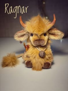 a stuffed animal that is sitting on a table with the words ragnar written above it