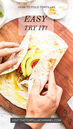 someone is making a tortilla with avocado on it and the text overlay reads how to fold tortillas easy try