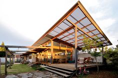 a house with a covered patio and stairs leading up to the front door, along with a bicycle parked on the porch