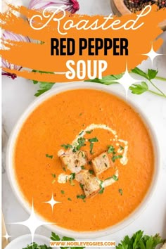 a bowl of roasted red pepper soup with croutons